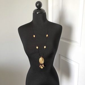 Nice, 17” drop, black cord necklace with gold/red accents